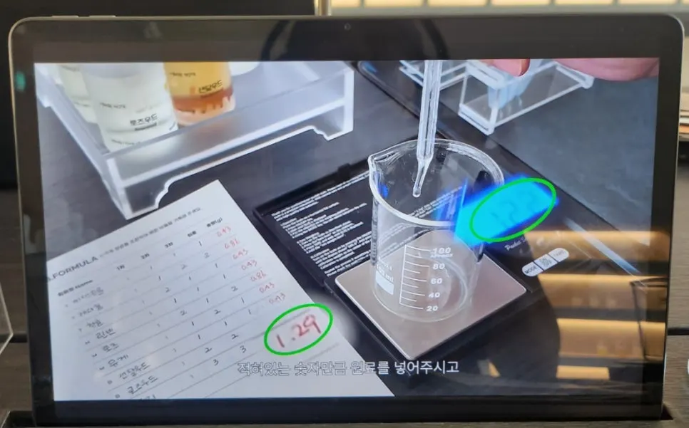Booklet and tablet explaining the perfume-making experience