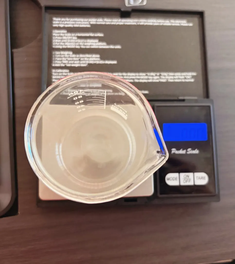 Measuring fragrance oil in a beaker on a scale
