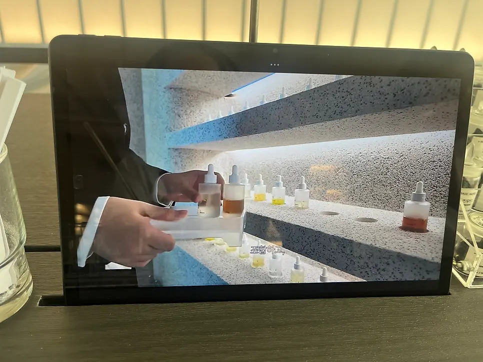Tablet screen explaining the perfume-making process