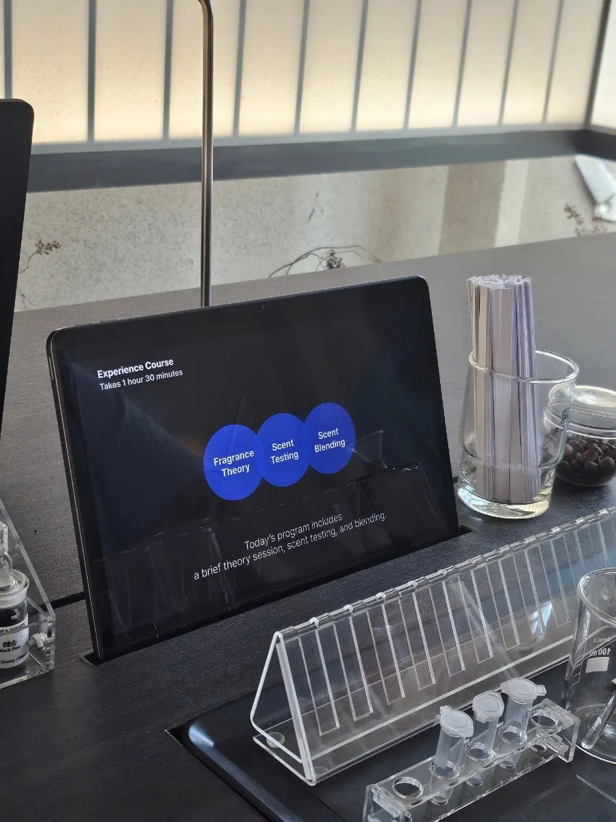 Perfume-blending station prepared with a tablet and theory notes