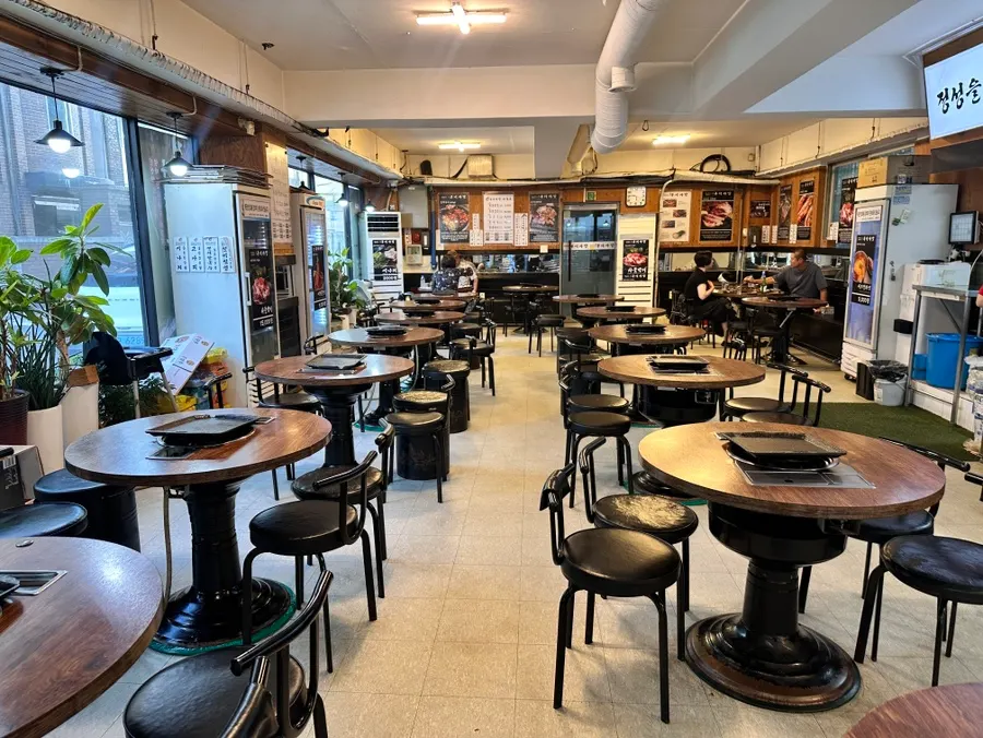 Guests enjoying meat in the spacious restaurant