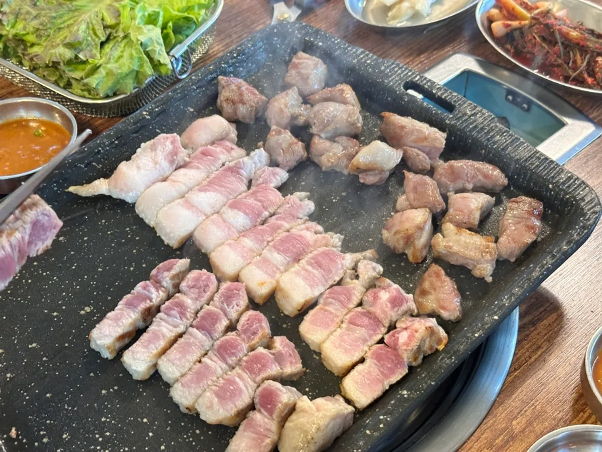 Pre-grilled whole pork belly finished on the tabletop grill