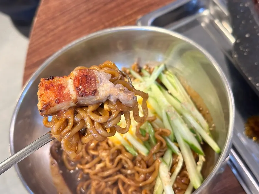 Jjagechi noodles and scallion kimchi wrapped around pork belly