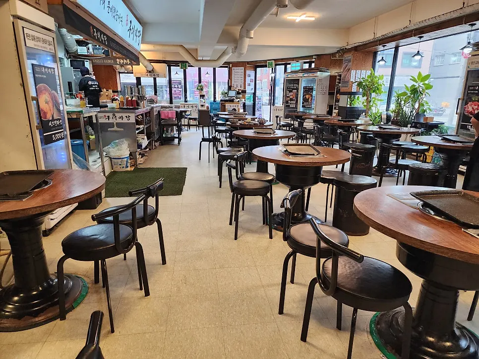 Restaurant interior with neatly arranged tables and grills