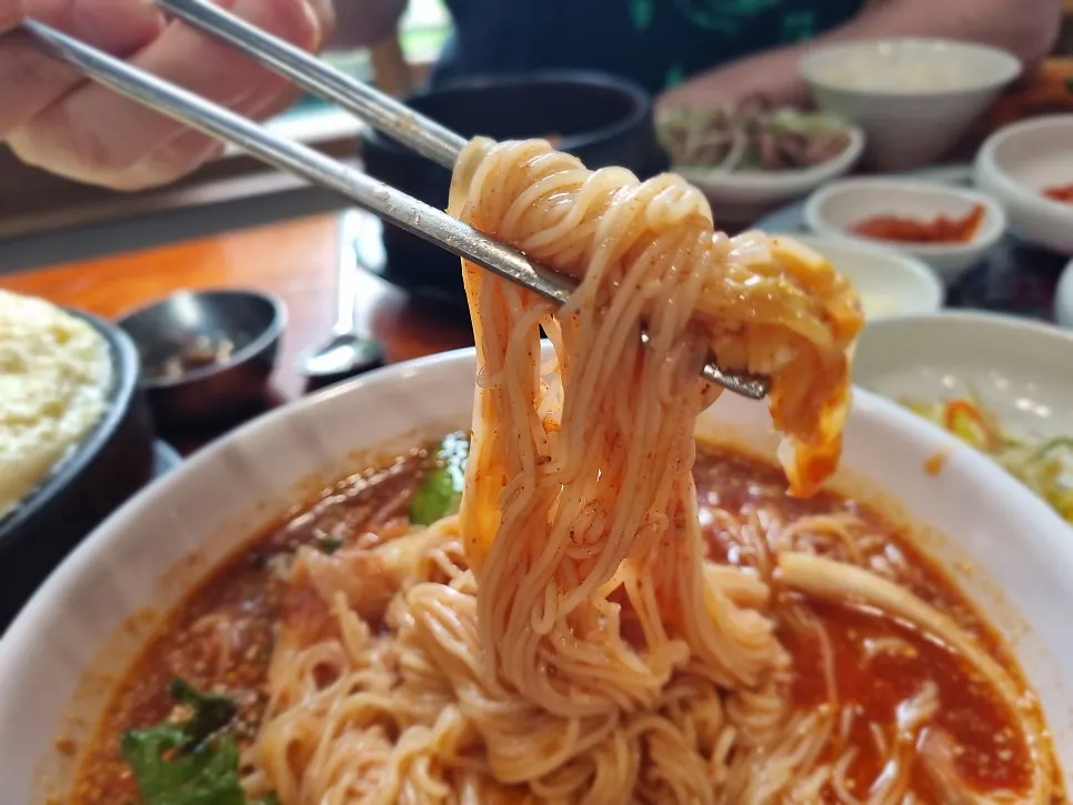 Charcoal bulgogi piled on top of the bibim noodles