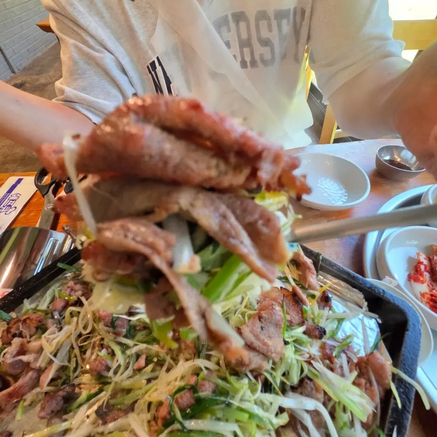 Charcoal scallion pancake bulgogi piled on a bowl of rice