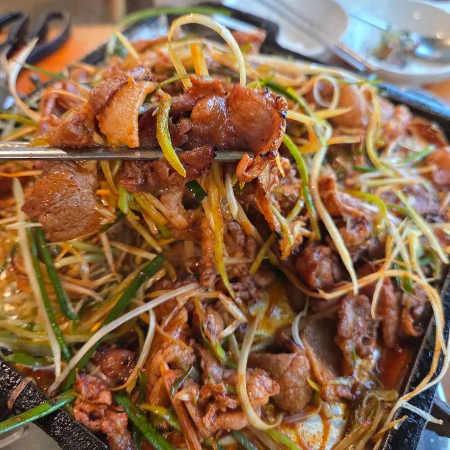 Taking a big bite of charcoal gochujang bulgogi
