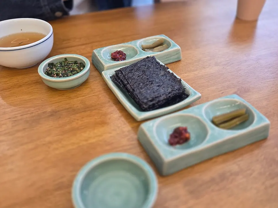 A Korean meal set served in teal ceramic bowls at Hyangtaek