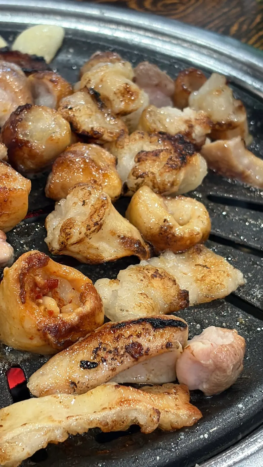Pre-grilled intestines being cooked further on the grill