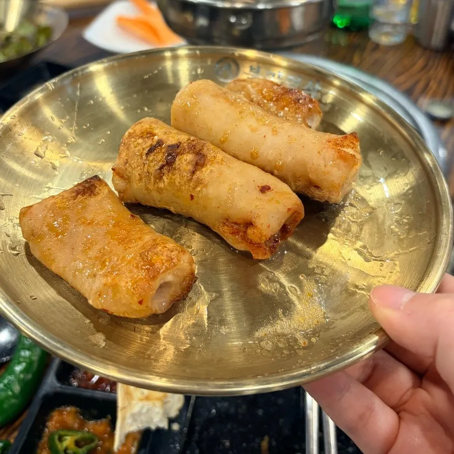 A piece of makchang dipped in sauce