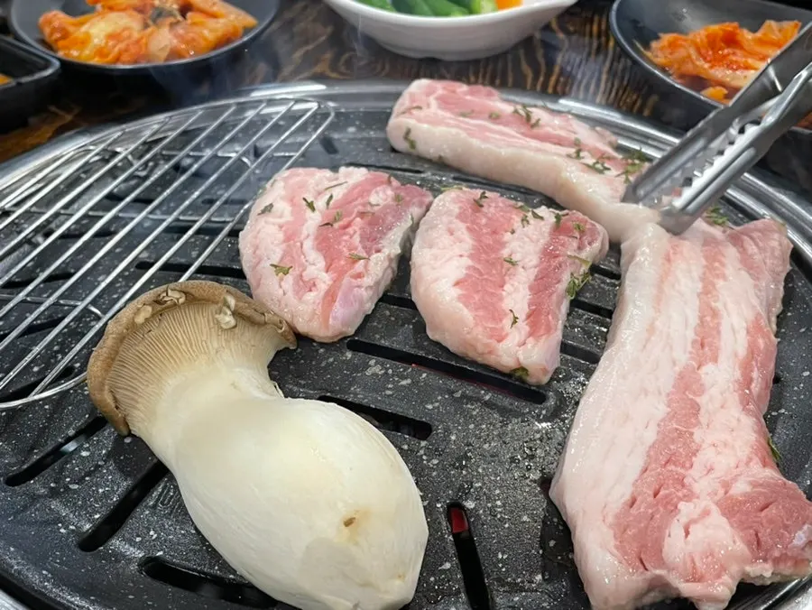 Plate of raw pork belly sprinkled with parsley