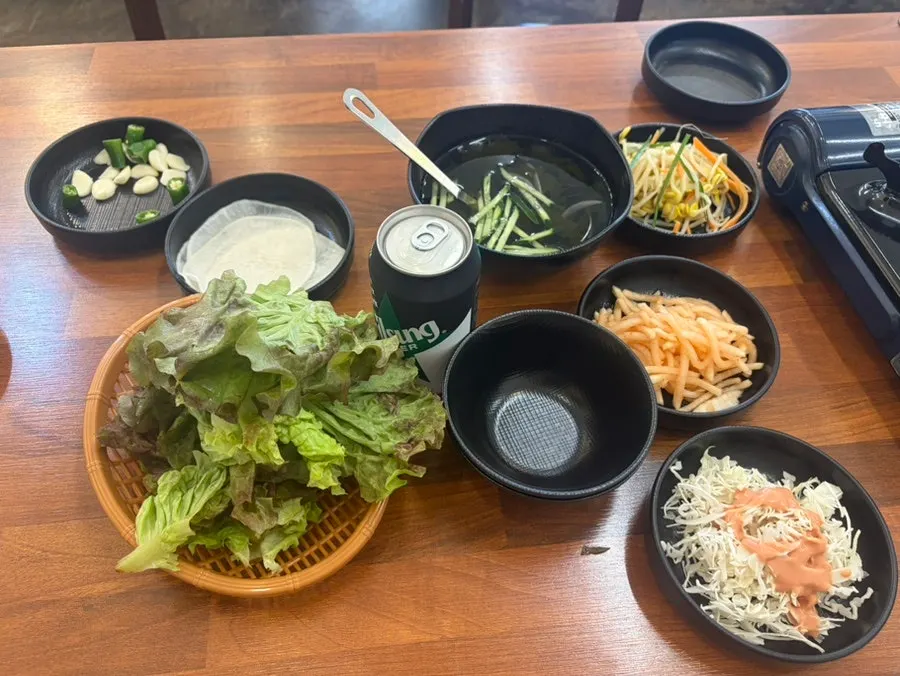 Table spread of lettuce wraps and cold seaweed soup as basic side dishes