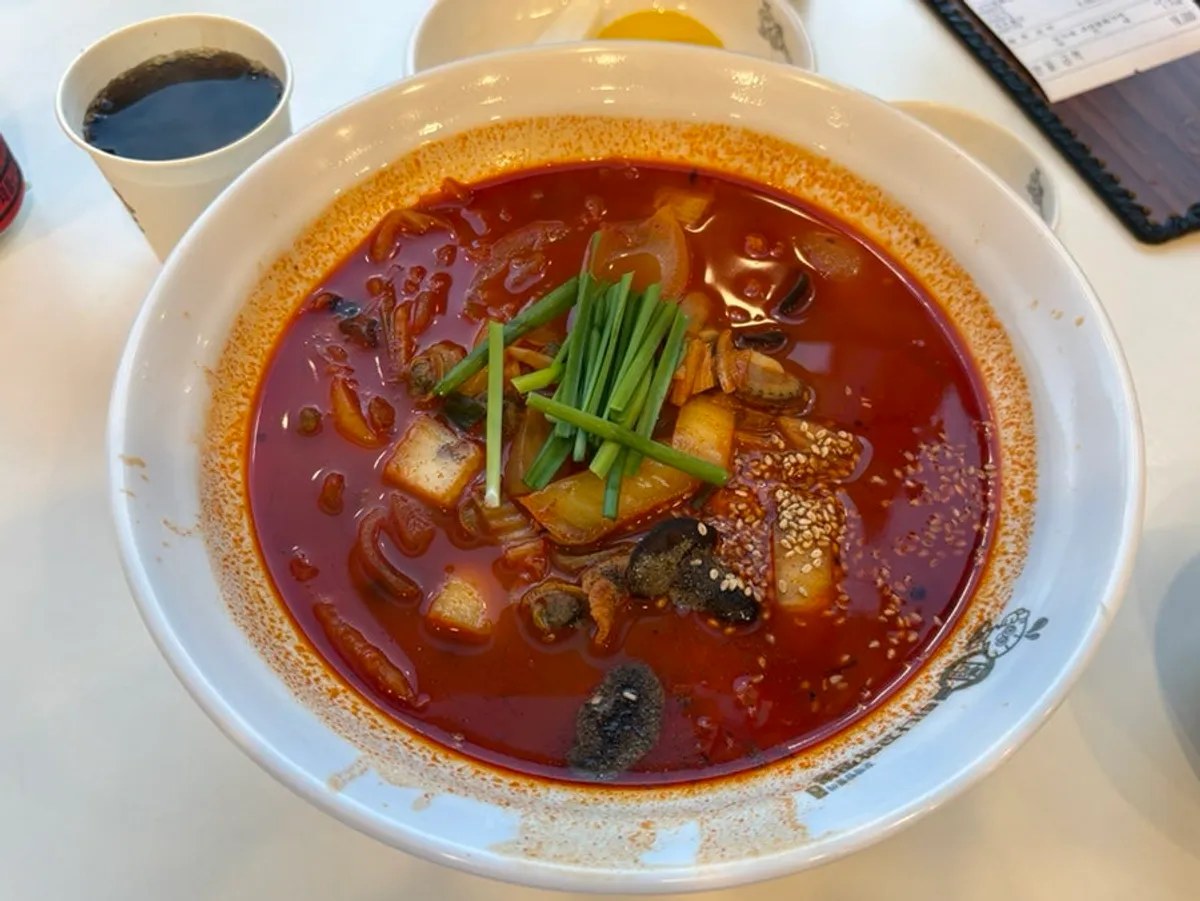 A bowl of spicy cockle jjamppong rice with rich broth