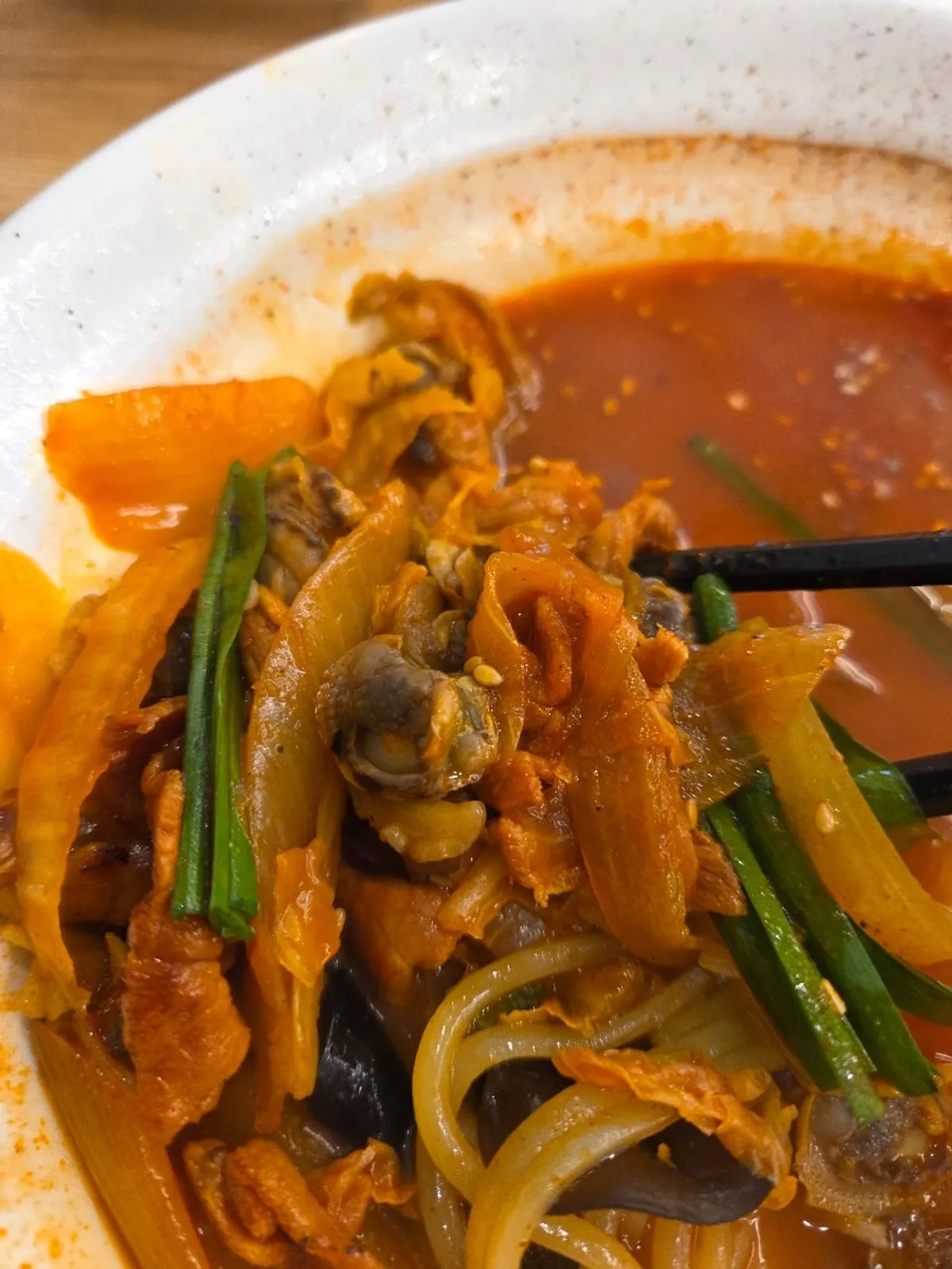 A spoonful of rice mixed into jjamppong broth