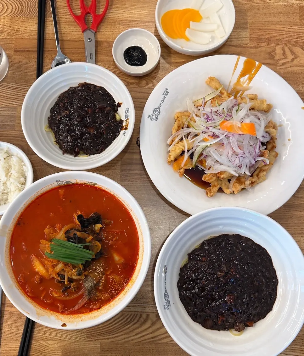 Full spread of cockle jjamppong, jjajangmyeon, and sweet-and-sour pork