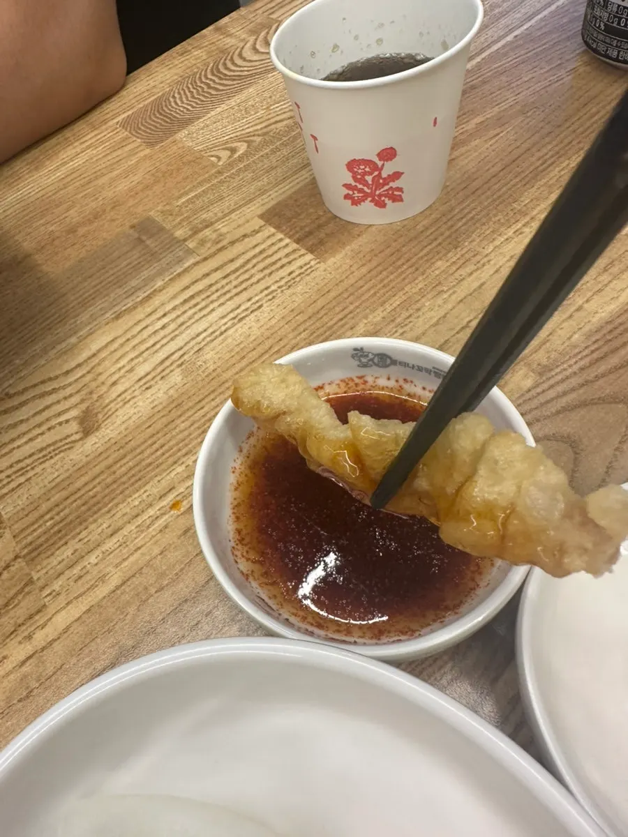 A piece of sweet-and-sour pork with thin batter