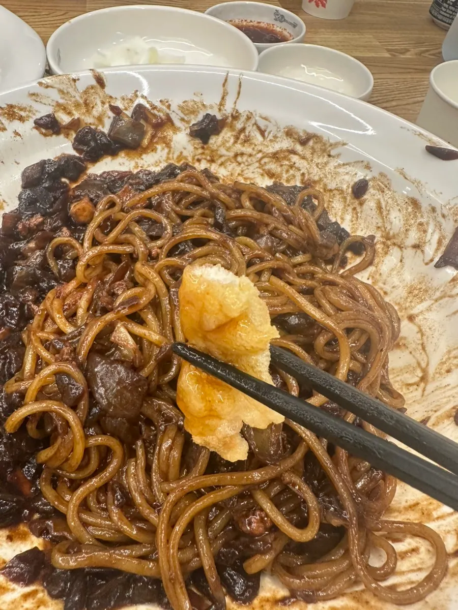 A piece of sweet-and-sour pork dipped in sauce