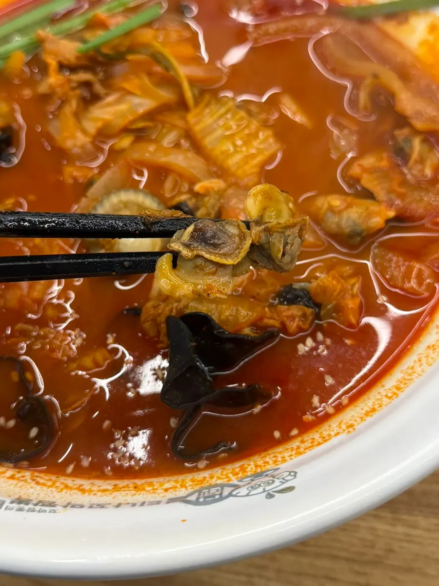 Rich jjamppong broth with meat mixed in
