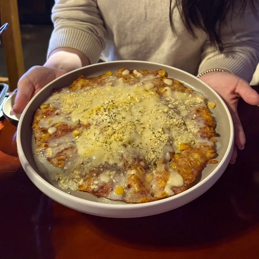Corn cheese pancake topped with condensed milk and injeolmi powder