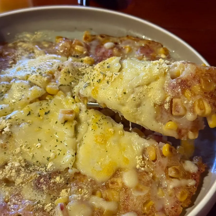 Cross-section of the corn cheese pancake with stretchy cheese