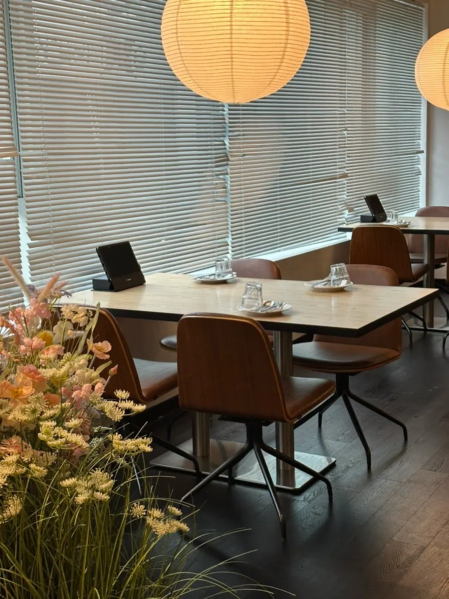 Widely spaced tables under pin lighting