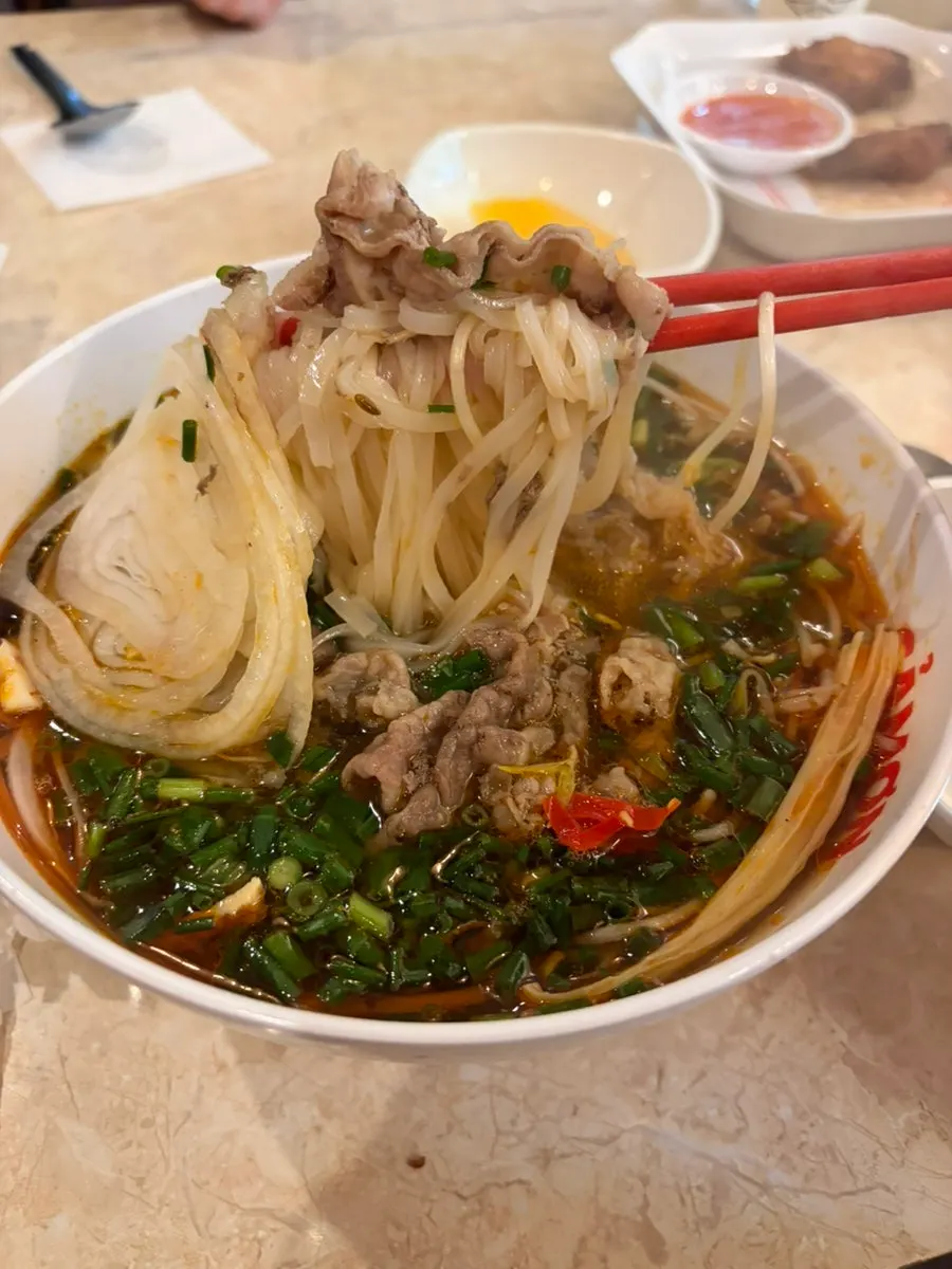 Table with mala pho and a side dish together