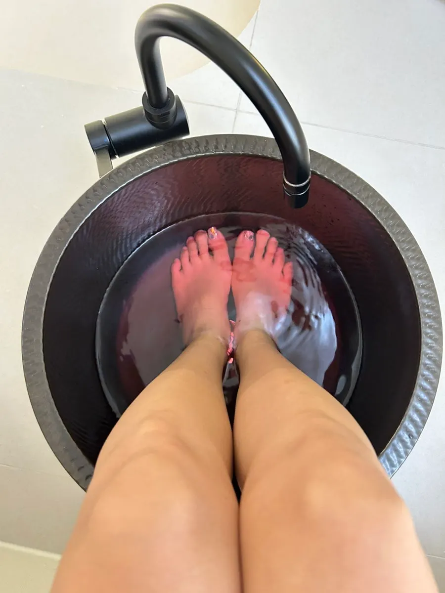 Feet soaking in warm foot bath water