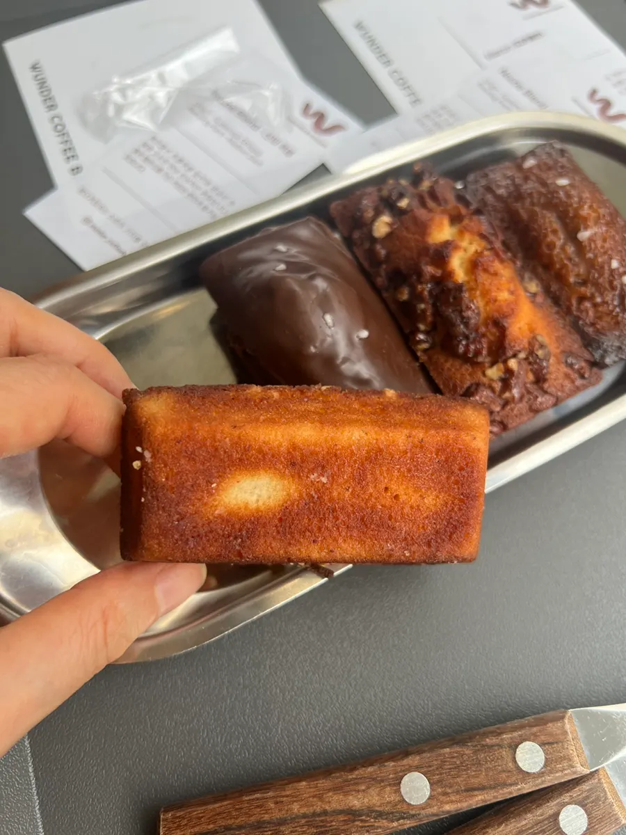 Iced latte placed next to financiers