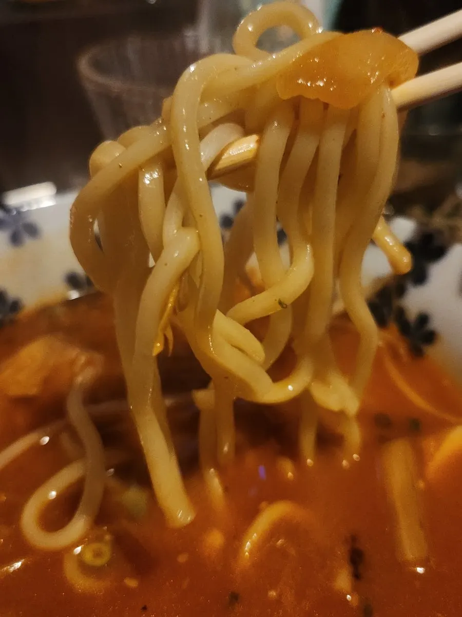 A bite of thick, mixed crab guts pasta