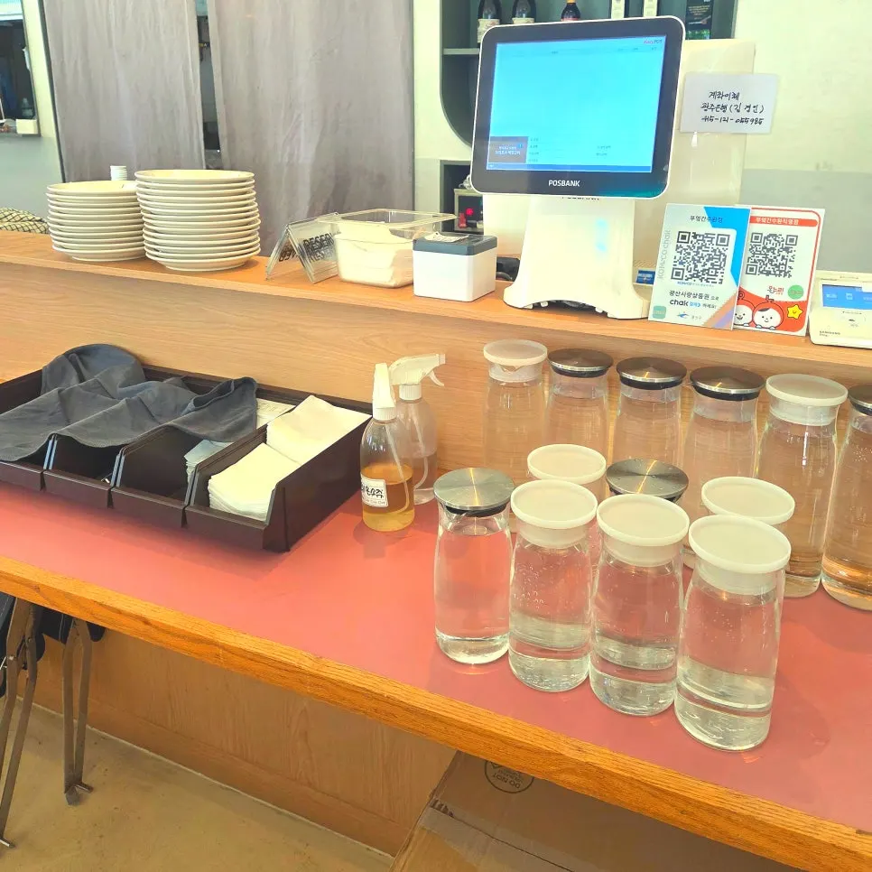Basic tableware and water neatly arranged by the counter