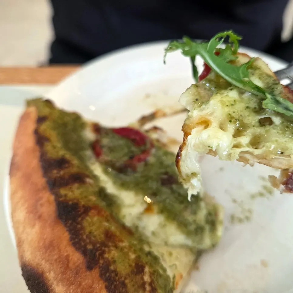 A slice of pizza topped with cheese and basil