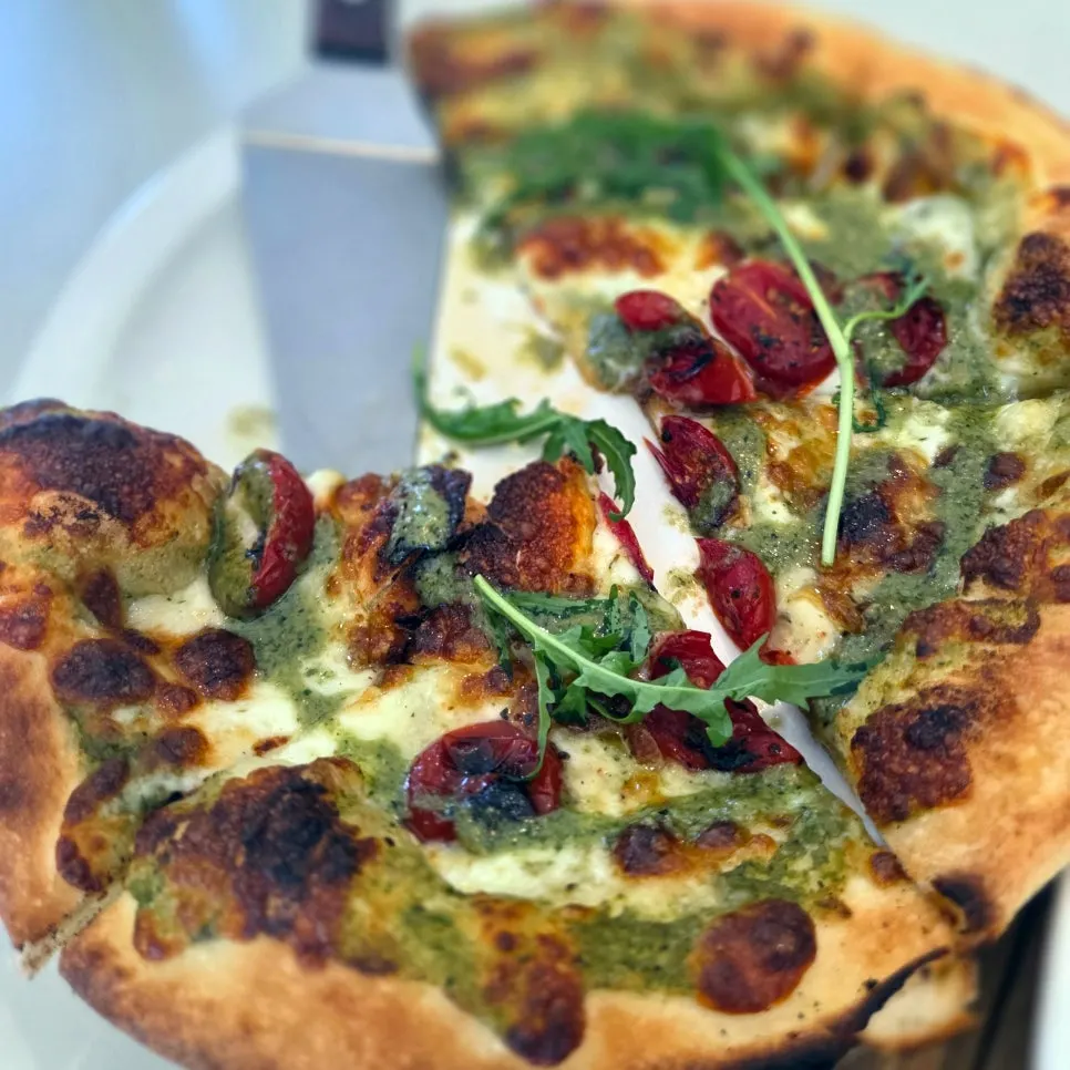 Cross-section of margherita pizza showing crispy dough