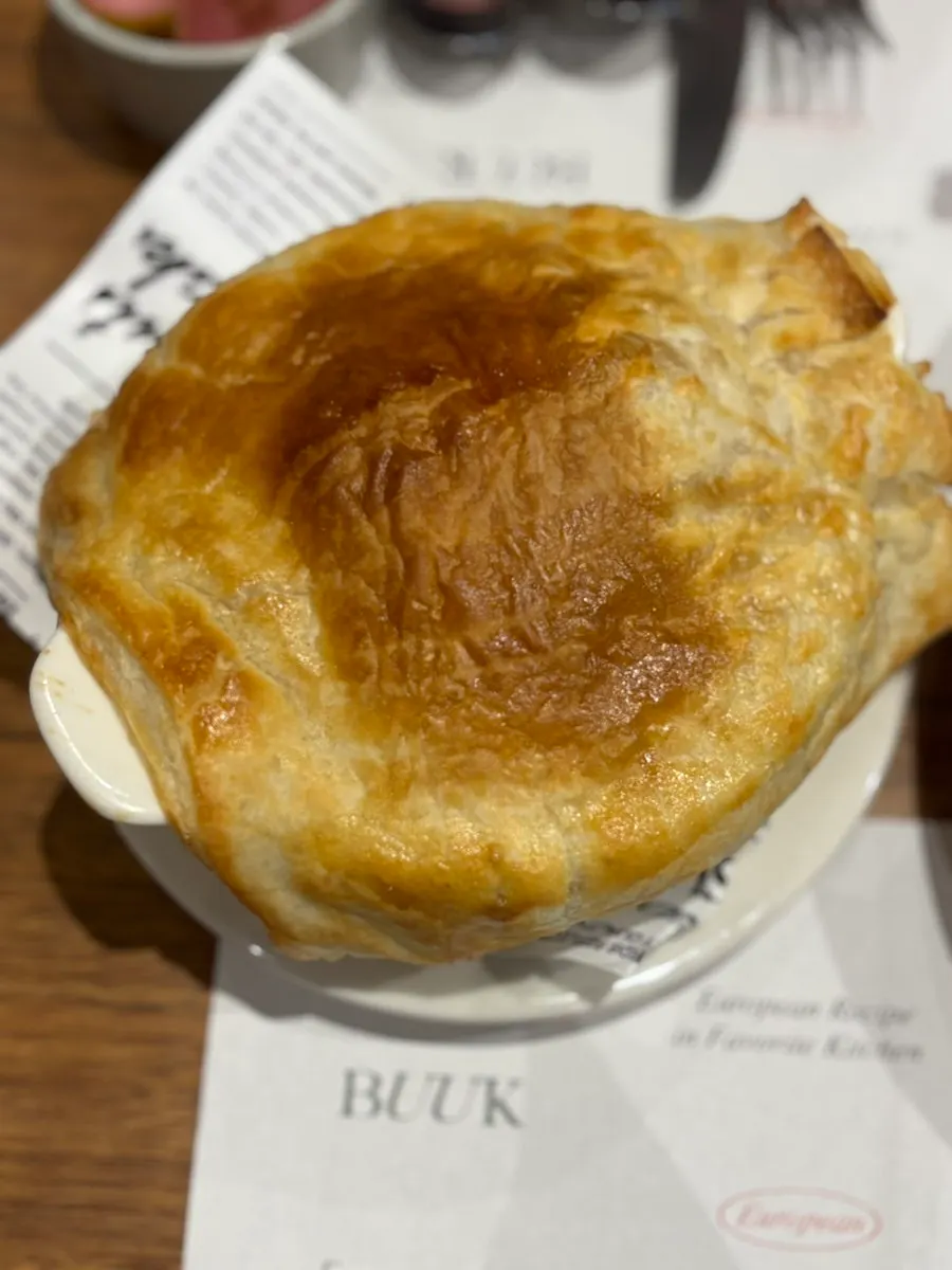 Sweet pumpkin pastry soup topped with pastry crust
