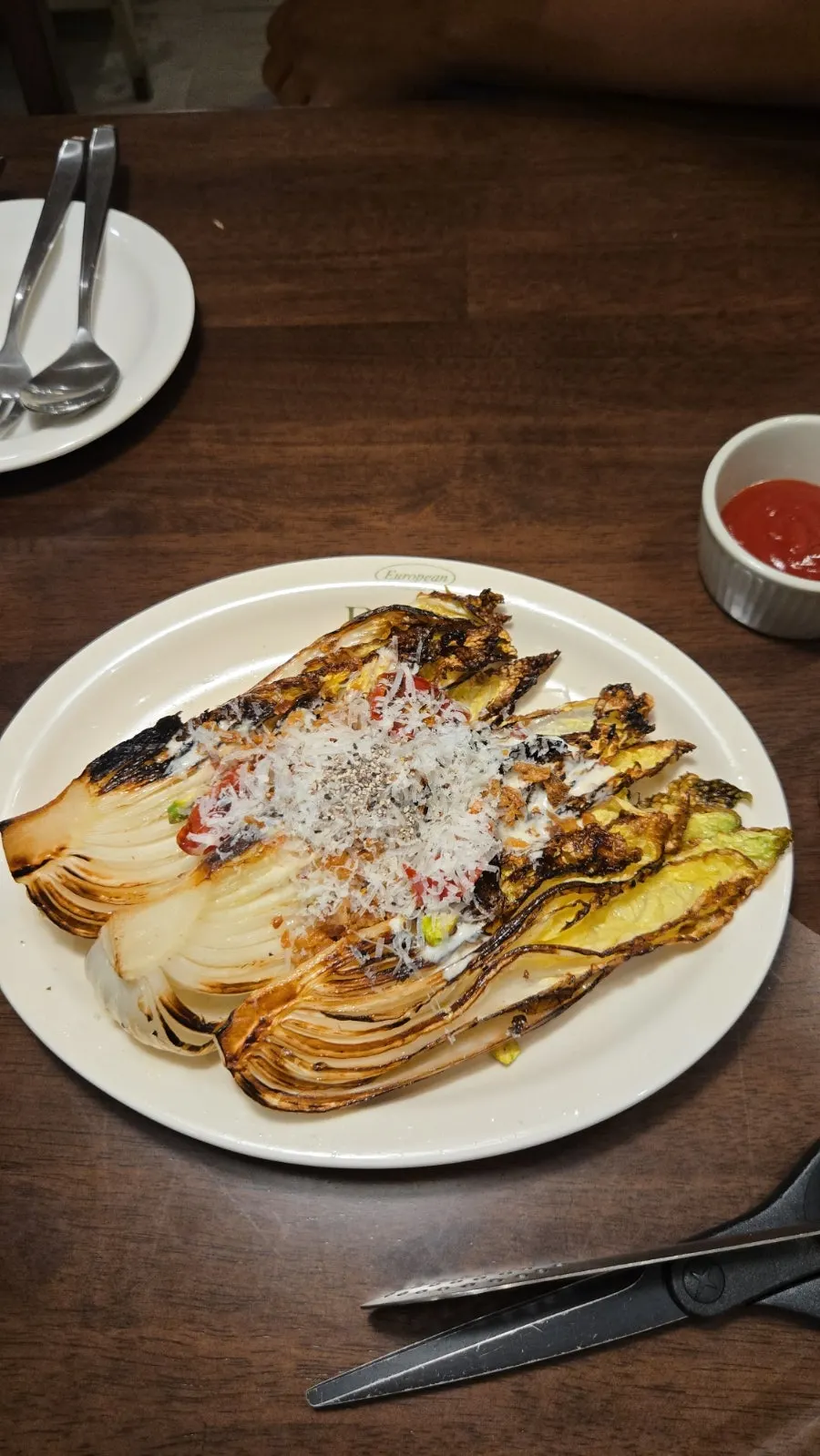 Whole grilled napa cabbage Caesar salad