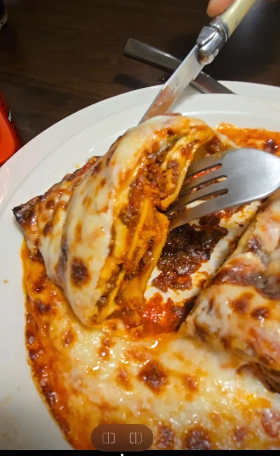 Spoonful of ragu sauce and lasagna sheets