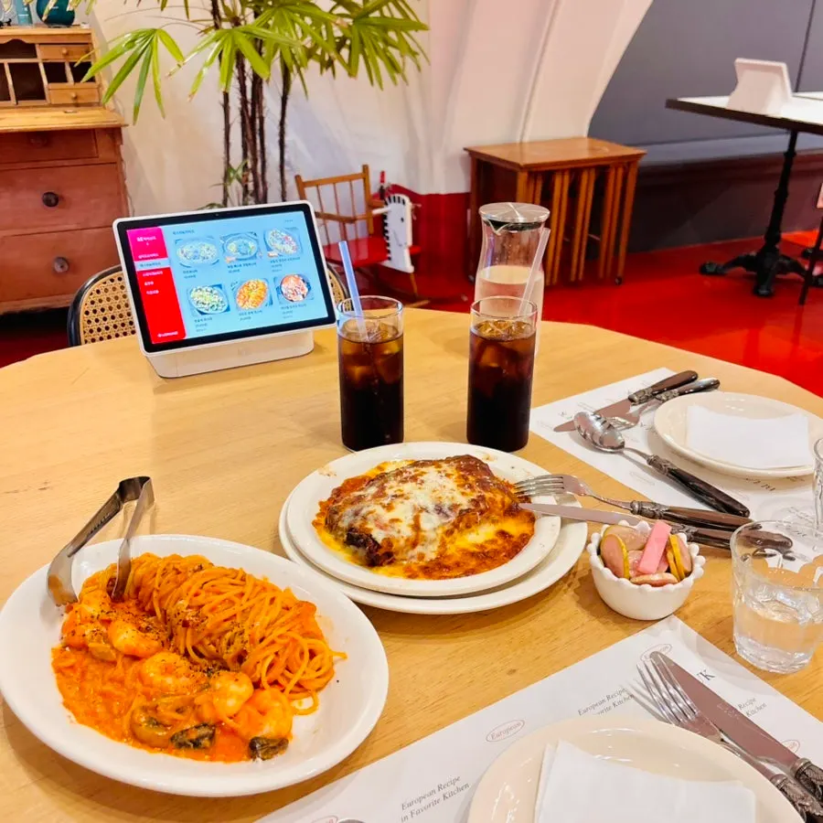 Shrimp rosé pasta, lasagna, and a soft drink served together