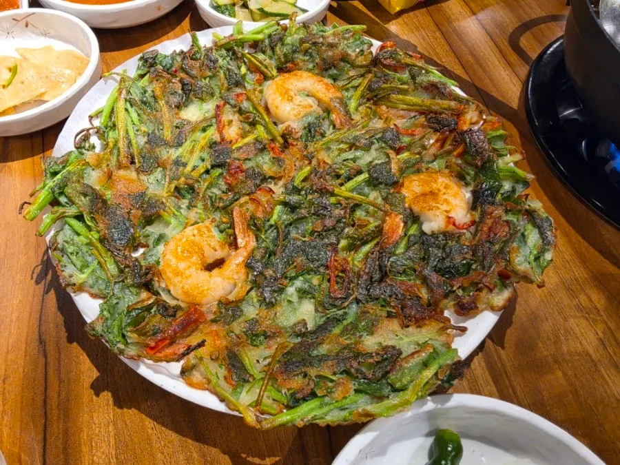 Gamjatang and pork belly main dishes laid out