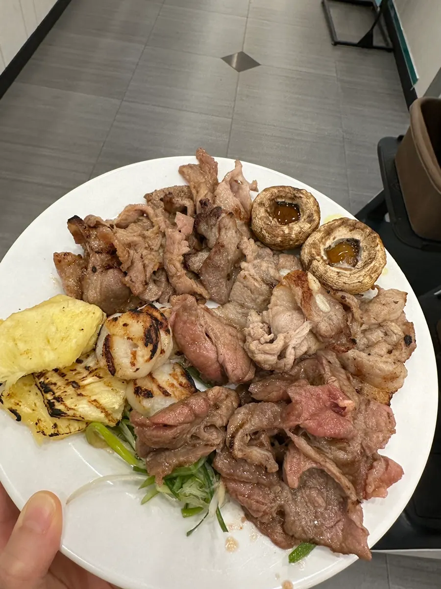 Mushrooms, pineapple and green onion grilling together