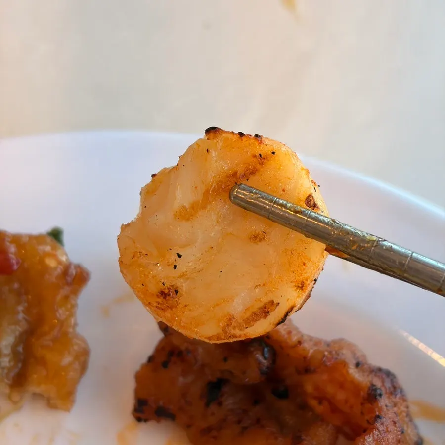 A plate of freshly grilled chicken feet and scallops