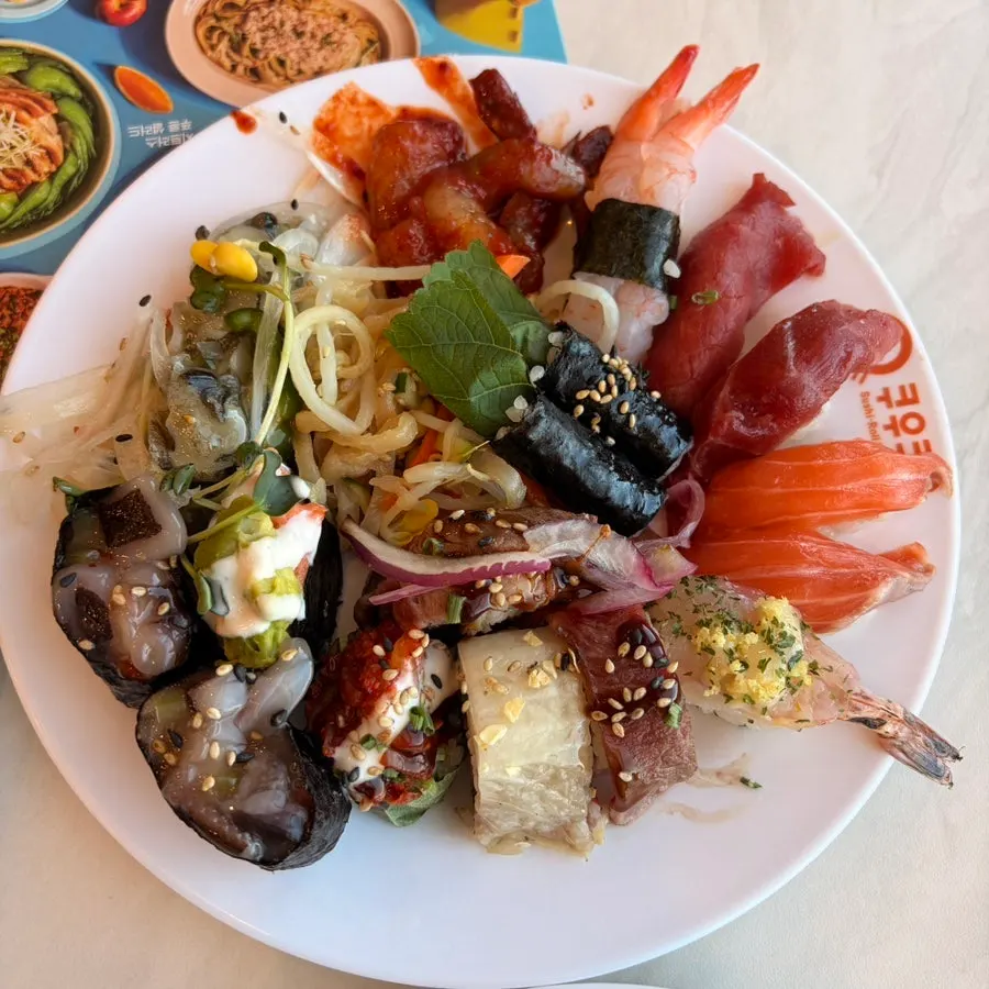 A plate of sushi with flounder, salmon, tuna, and more