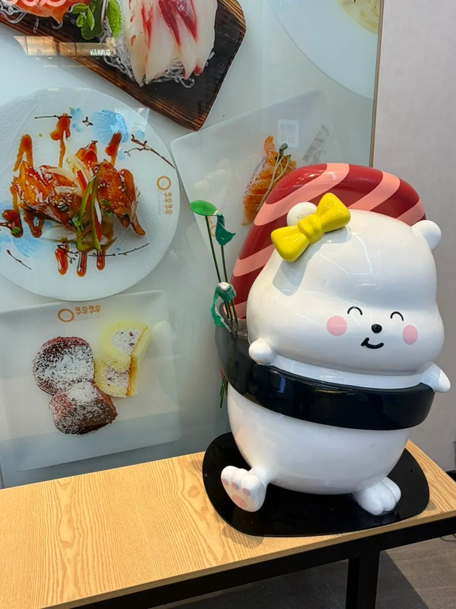 A sushi-shaped plush displayed in the restaurant