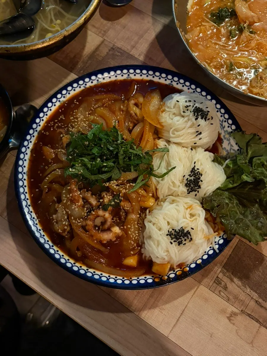 Octopus stir-fry topped with julienned perilla leaves at Bupyeong Pocha
