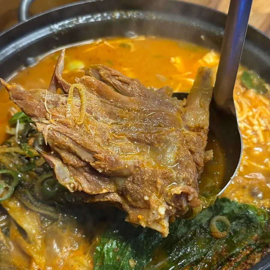 Large pork bone chunks inside the gamjatang pot