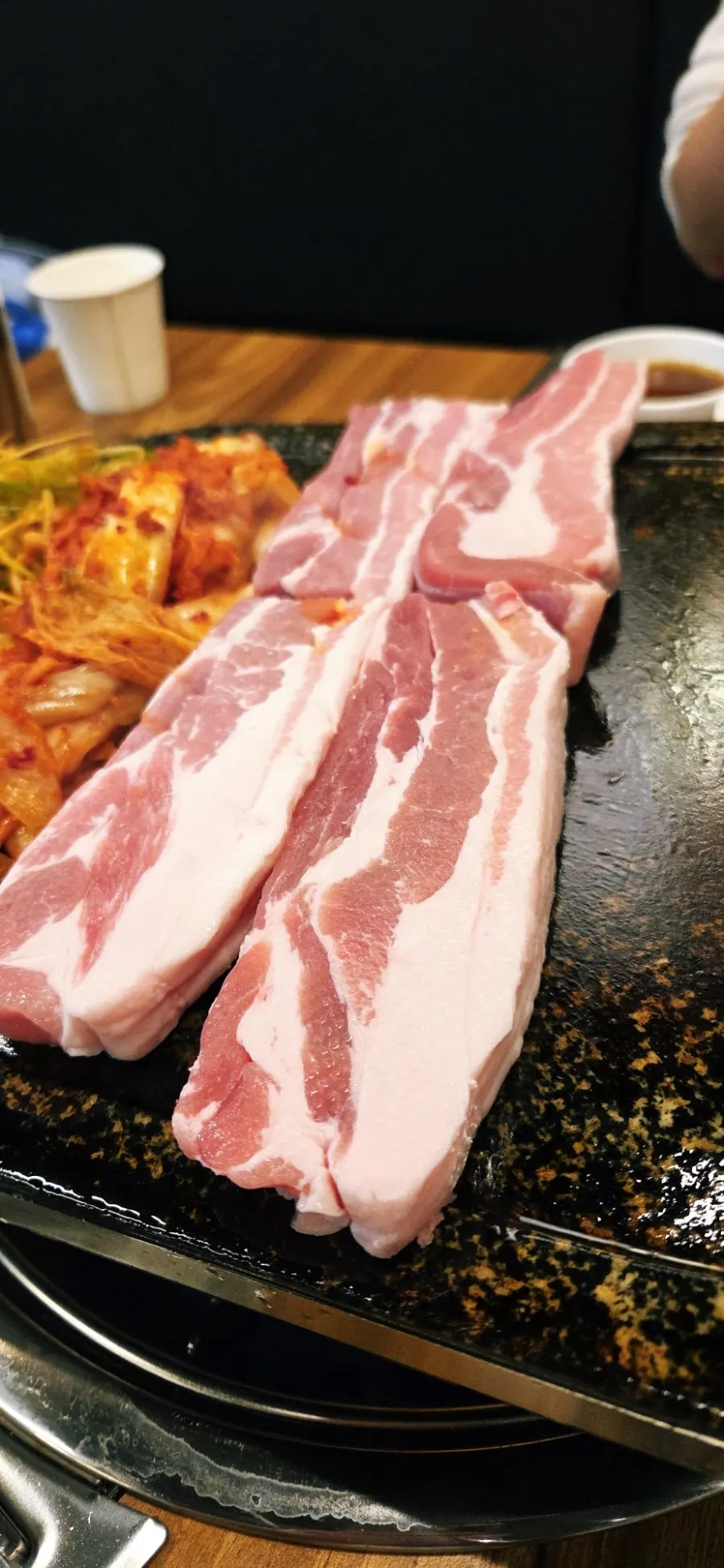 Raw pork belly with side dishes set on the table