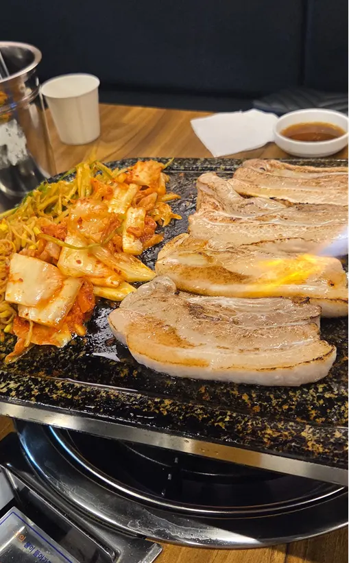 Pork belly grilling on the stone plate