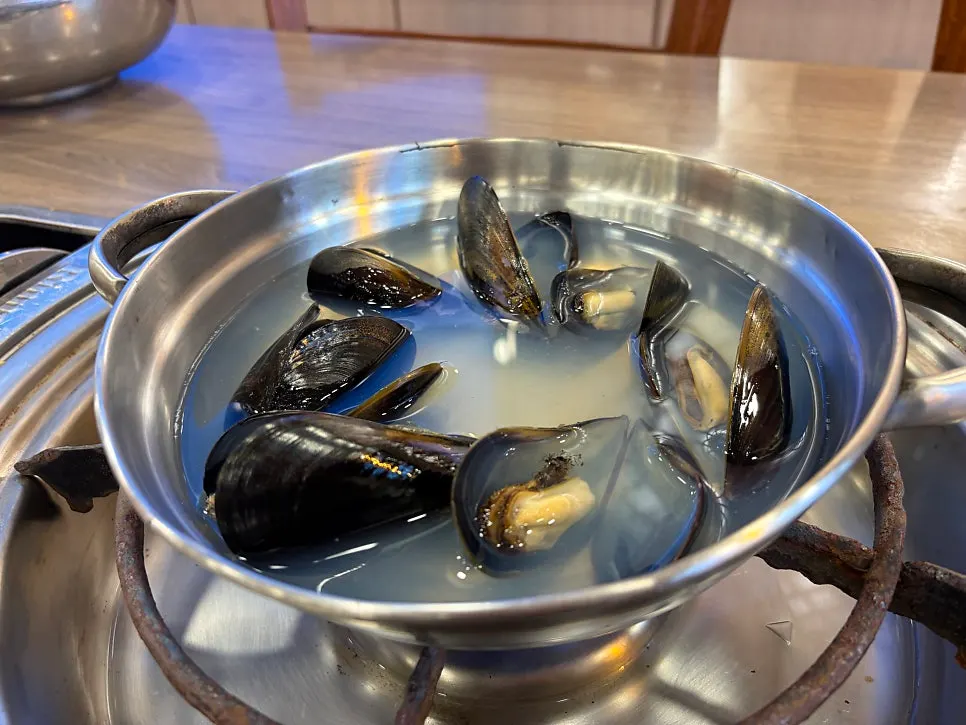 Complimentary side dishes served with seafood stew