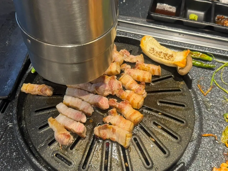 Pork belly on a charcoal grill