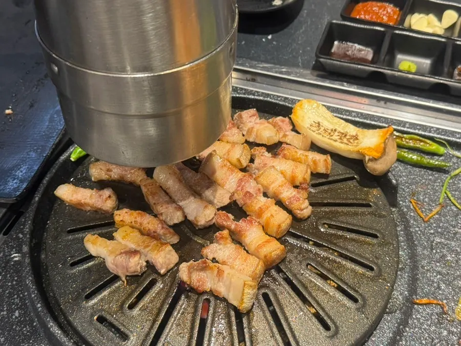 Staff grilling pork belly