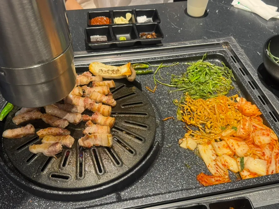 Pork belly and accompaniments on the grill