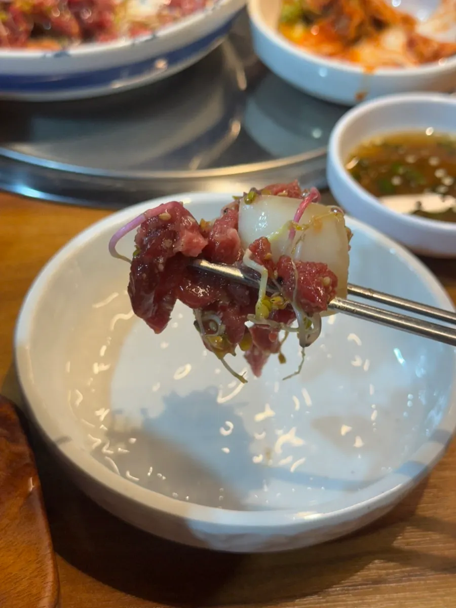 Yukhoe served with young greens